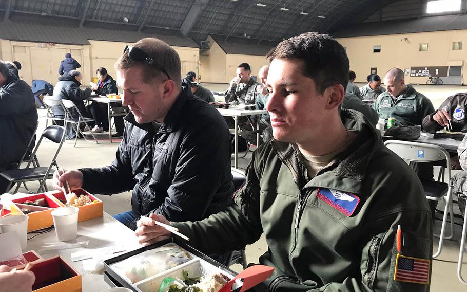Air Force captains Jonathan Coffey, left, and Emerson Woerner eat lunch with others involved in the filming of "Fukushima 50" at Yokota Air Base, Japan, Monday, Jan. 28, 2019.