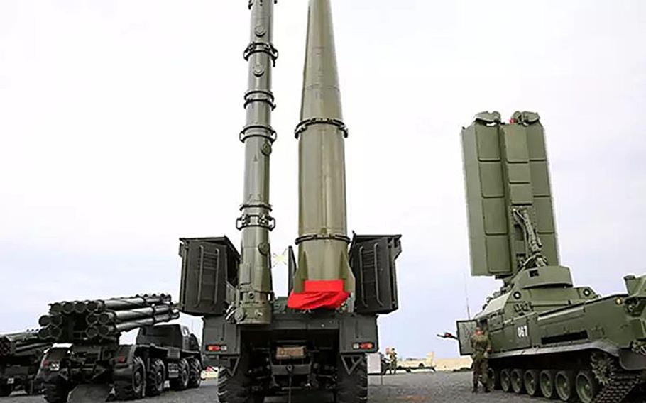 A Russian 9M728 cruise missile container, left on the truck at center, stands next to a 9M723 short-range ballistic missile. The U.S. says Russia’s new 9M729 ground-launched missile violates the INF treaty. A U.S. deadline for compliance with the treaty expires Saturday.