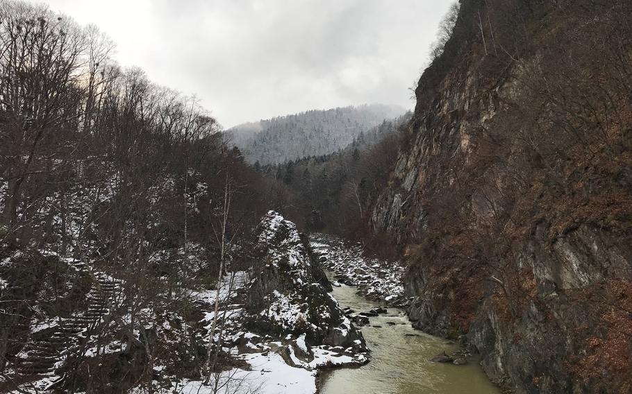 Standing on the Futami Suspension Bridge over the Toyohira River provides sweeping views of the Jozankei Onsen region.