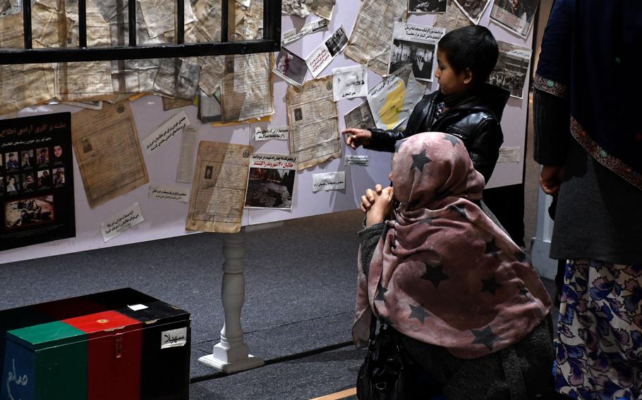 A mother and son visit the newly opened Center for Memory and Dialogue in Kabul on Feb. 27, 2019. The Center honors the memory of Afghans killed during the past four decades of violence in the country.