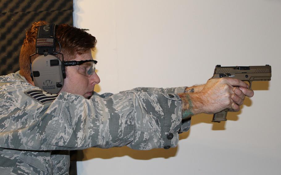Tech. Sgt. Brady Craddock, Air Force Gunsmith Shop noncommissioned officer in charge, fires an M18 handgun. The Air Force Security Forces Center, in partnership with the Air Force Small Arms Program Office, began fielding the new M18 Modular Handgun System to all security forces units.