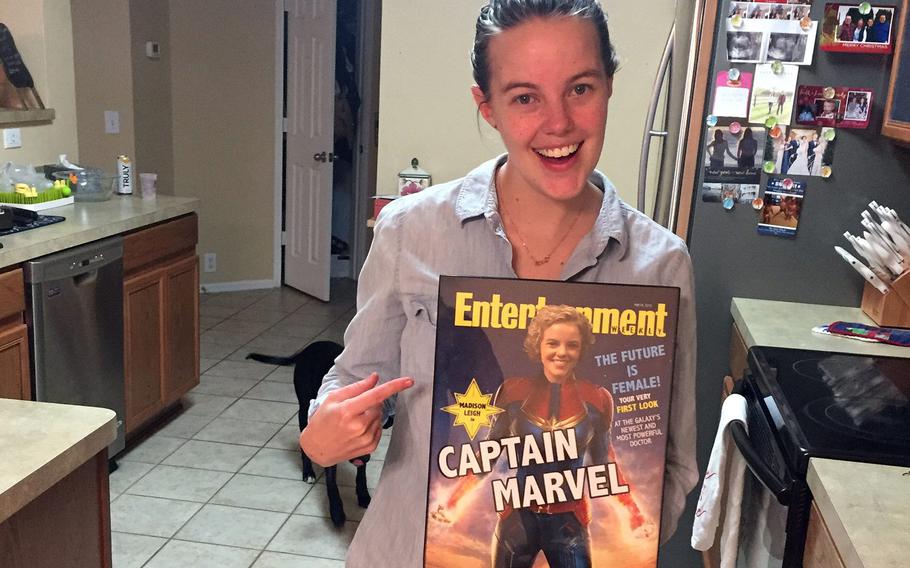 Air Force Capt. Madison Marvel is pictured here on Wednesday, March 6, 2019, holding a poster her parents made for her, which put her face on the body of Brie Larson in costume as superhero Captain Marvel on a September 2018 cover of ''Entertainment Weekly.''