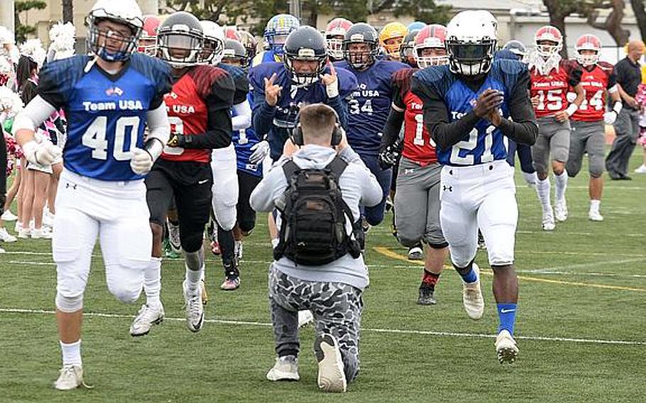 Players from Team USA, comprised of football players from 10 DODEA Pacific schools, make their way onto the field at Reid Memorial Stadium, Naval Air Facility Atsugi, Japan, March 10, 2019, for the eighth Tomodachi Bowl friendship game.