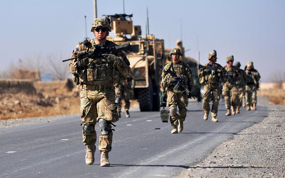 U.S. soldiers move toward a village near Forward Operating Base Zangabad in Kandahar province, Afghanistan, in 2013. The U. S. and the Taliban have drafted an agreement in principle on two of four core issues at the center of peace talks intended to end America's longest war.