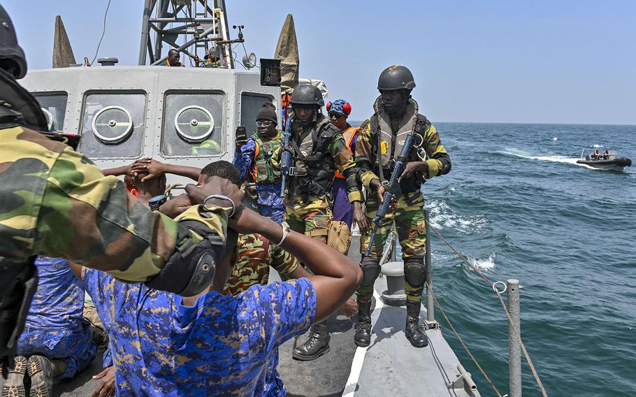 Members of the Senegalese and Gambian navies conduct a simulated search-and-seizure raid during a drug smuggling and human trafficking scenario aboard a Gambian patrol vessel on March 18, 2019 during Obangame Express. The U.S.-led exercise brought together 33 countries to practice teamwork in combating seagoing crimes in West African waters.