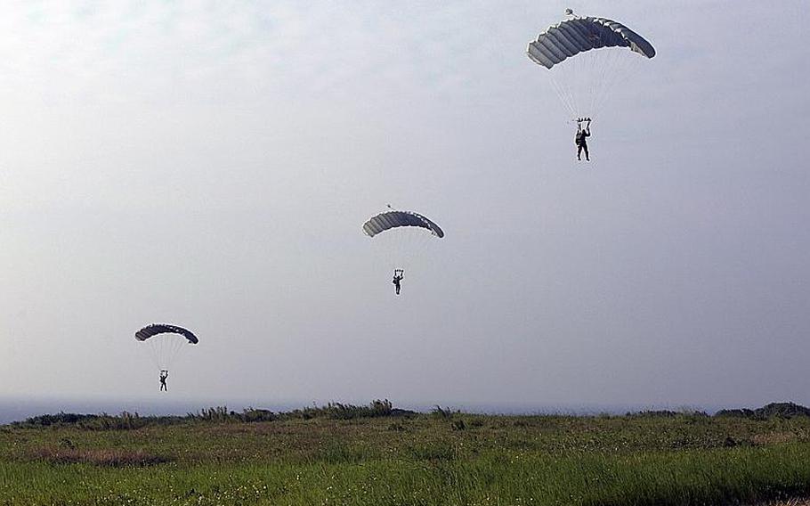 Members of the 31st Marine Expeditionary Unit parachute on Ie Shima during past training on the island off the west coast of Okinawa, Japan.