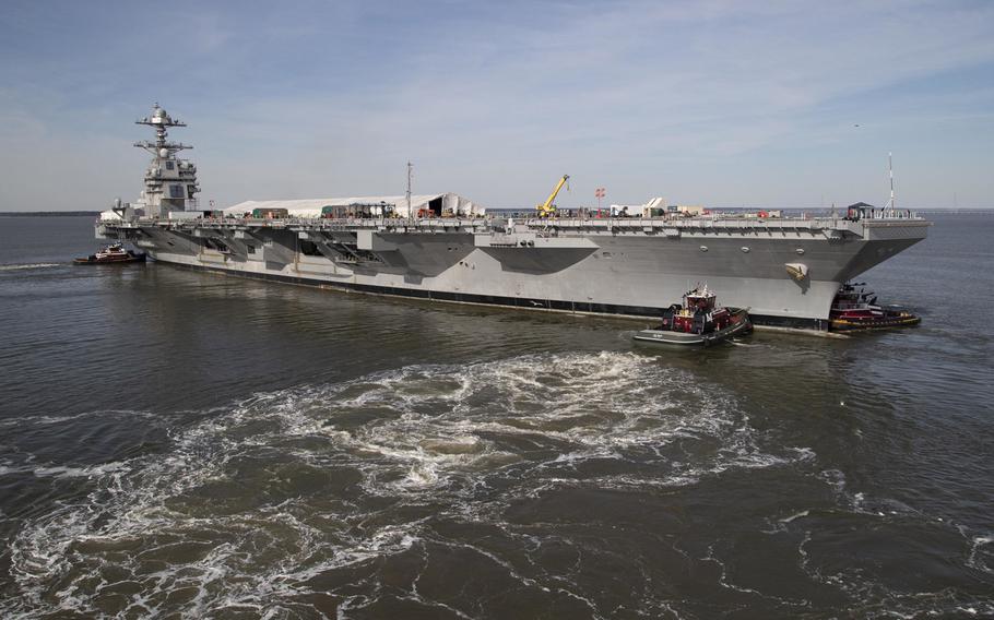 The USS Gerald R. Ford is maneuvered by tugboats in the James River during Ford's turn ship evolution, March 17, 2019. Fixing the aircraft carrier's nuclear propulsion system will cause a three-month in its joining the fleet.