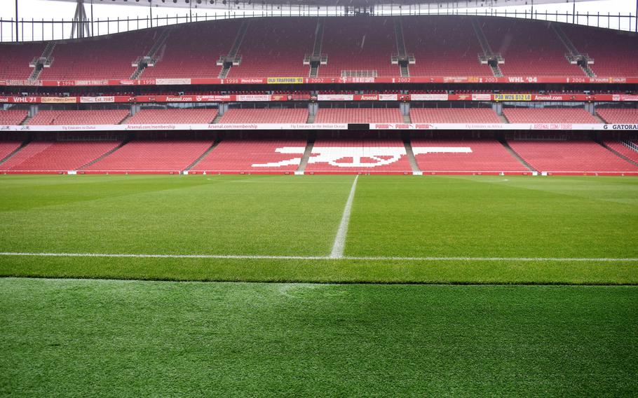 The iconic cannon insignia of the Arsenal soccer team is painted into the lower bowl of Emirates Stadium in London. A tour of the stadium offers visitors a chance to sit in the field-level seats of the team's players and coaches.