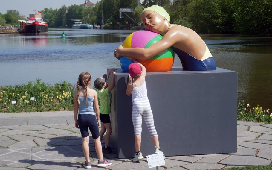 A trio of children check out Monumental Brooke with Beach Ball at the Bundesgartenschau in Heilbronn, Germany. There are a number of art works to be seen among the flowers and plants at the federal garden show that lasts until Oct. 6.