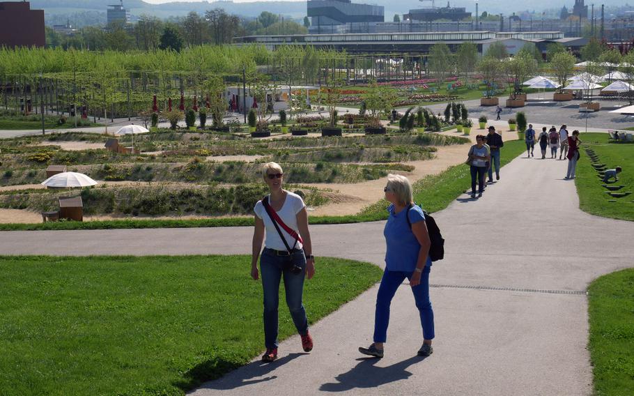 Visitors walk through the vast grounds of the Bundesgartenschau in Heilbronn, Germany. It is built on what was once a freight depot and switching yard.