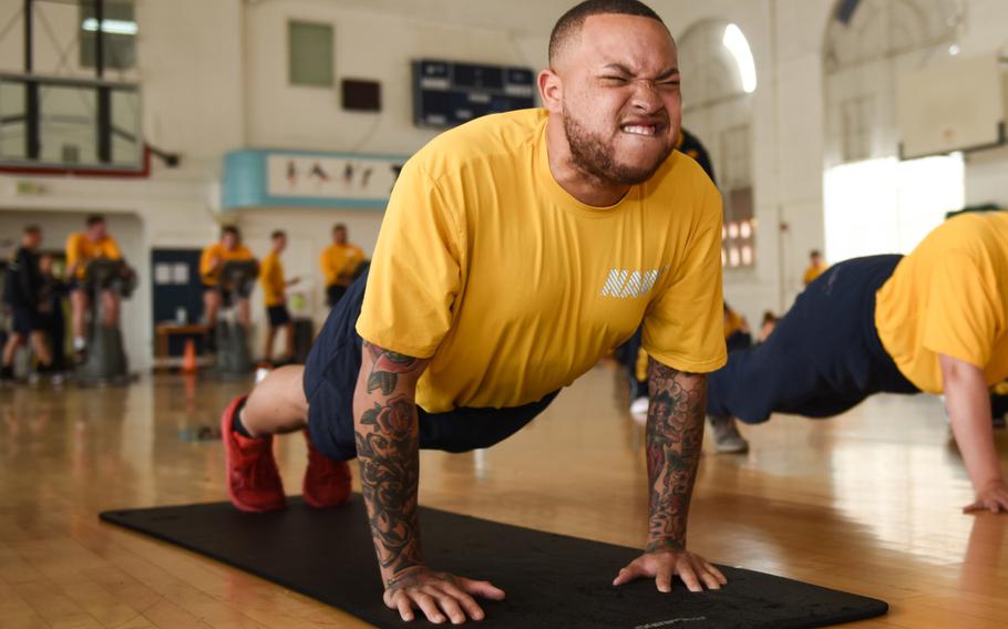 Petty Officer 2nd Class Alexander Love, assigned to the aircraft carrier USS Theodore Roosevelt, completes a pushup during the spring 2019 physical readiness test, April 23, 2019. The Navy has issued guidelines to halt physical training of sailors who show unusual distress and let them make up the training another day.