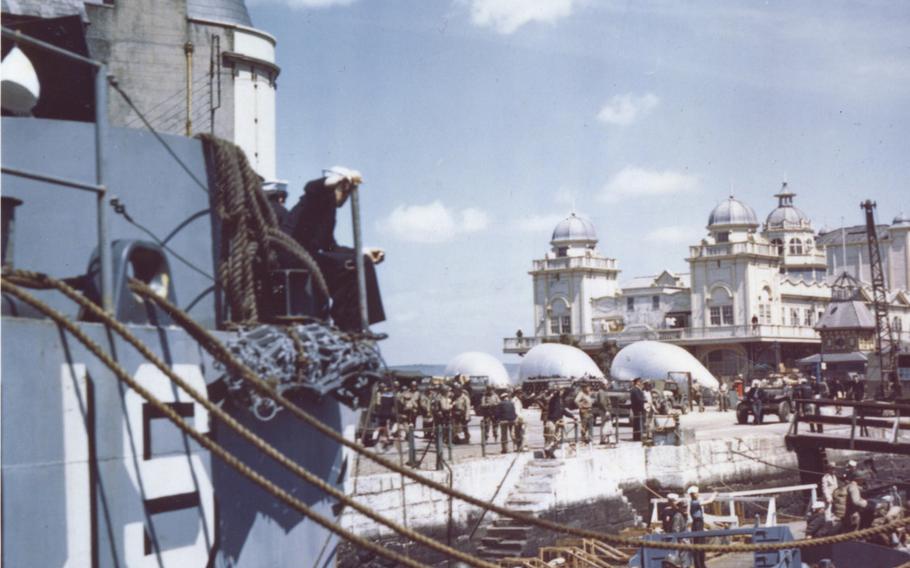 In June 1944, American troops at Weymouth, England, descend into barges which will take them to troop ships from which they will launch the attack against Hitler's Fortress Europe. Barrage balloons float in the background.