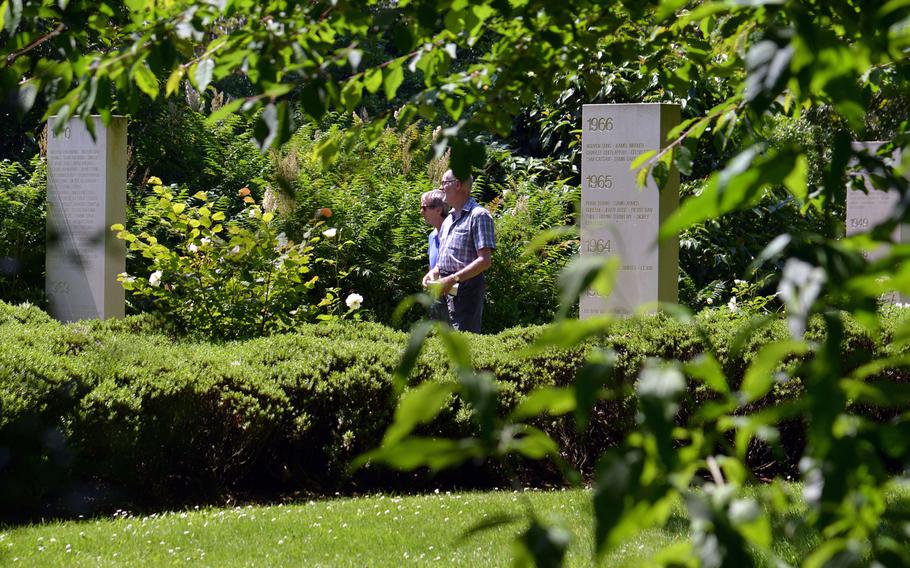 Visitors walks through the Memorial des Reporters, or Reporters Memorial, a park that on concrete slabs lists the names of over 2,000 journalists killed in the line of duty around the world since 1944.