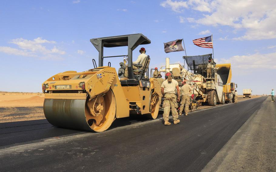 Airmen assigned to the 31st Expeditionary Squadron use a steamroller to level asphalt while paving a flight line on Nigerien Air Base 201, Niger, in December 2018. The U.S. military?s new base is scheduled to open this summer.