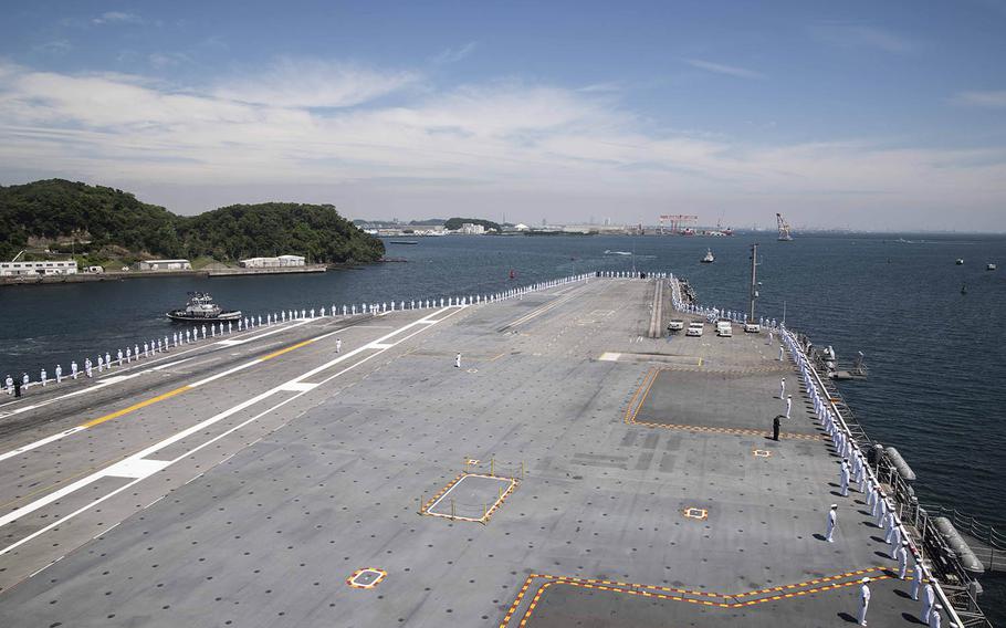 Sailors man the rails on the flight deck of the USS Ronald Reagan as the aircraft carrier departs Yokosuka Naval Base, Japan, Wednesday, May 22, 2019.