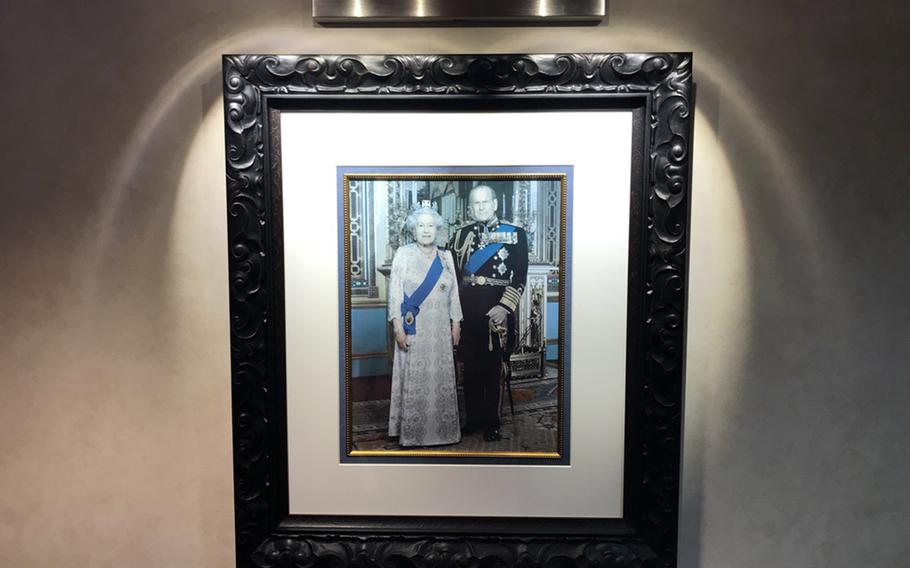 A photo of the Queen Elizabeth II and Prince Philip Mountbatten hangs in the officer's lounge of the HMAS Adelaide, Tuesday, July 16, 2019.