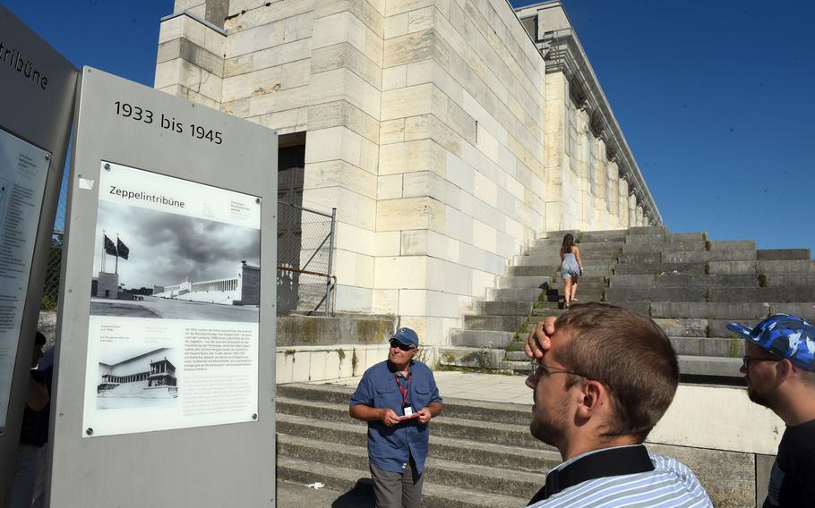 Tourists walk around the viewing area of the Nazi Party Rally Grounds in Nuremberg, Germany.