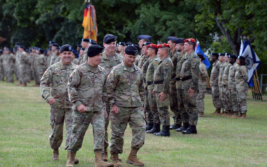 The outgoing commander of the 21st Theater Sustainment Command, Maj. Gen. Steven A. Shapiro, ceremony commander of troops Col. William S. Galbraith, incoming commander Maj. Gen. Christopher O. Mohan and U.S. Army Europe commander Lt. Gen. Christopher G. Cavoli, from left, inspect the troops during the 21st TSC?s change of command ceremony in Kaiserslautern, Germany, Wednesday, July 31, 2019.