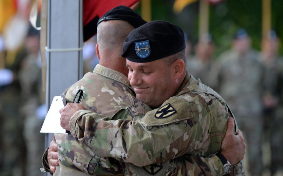 The outgoing commander of the 21st Theater Sustainment Command, Maj. Gen. Steven A. Shapiro, right, embraces U.S. Army Europe commander Lt. Gen. Christopher G. Cavoli at the 21st TSC change of command ceremony in Kaiserslautern, Germany, Wednesday, July 31, 2019. Maj. Gen. Christopher O. Mohan took over from Shapiro at the ceremony.