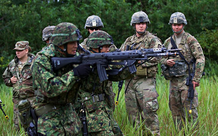 Soldiers with the Indiana National Guard's 76th Infantry Brigade Combat Team watch a care-under-fire demonstration by members of the Japan Ground Self-Defense Force during Orient Shield 2018 in Miyagi prefecture, Japan.