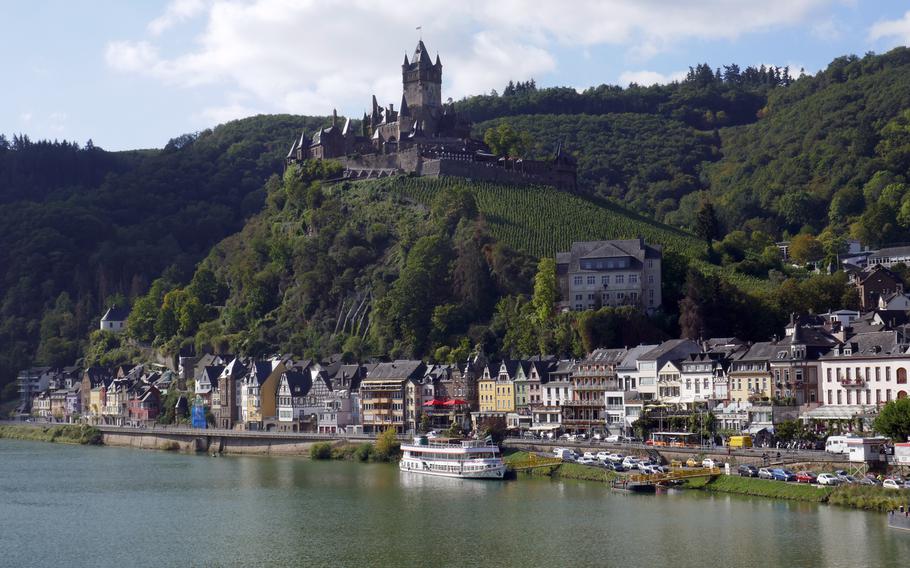 The Reichsburg Cochem towers over the city and the Moselle River. Parts of the castle date back to the 11th century and the town is a popular tourist destination.