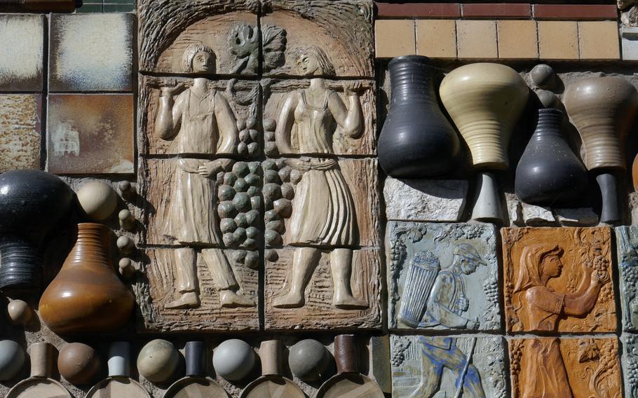 Cochem, on the Moselle River, is famous for its wine and vineyards. Here tiles on a house has many grape harvest motifs.