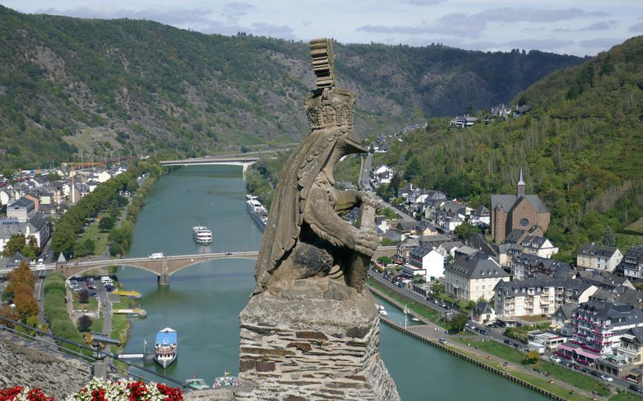 A stone knight looks out from the Reichsburg high over Cochem, Germany, and the Moselle River valley. The castle was first built in the 11th century.