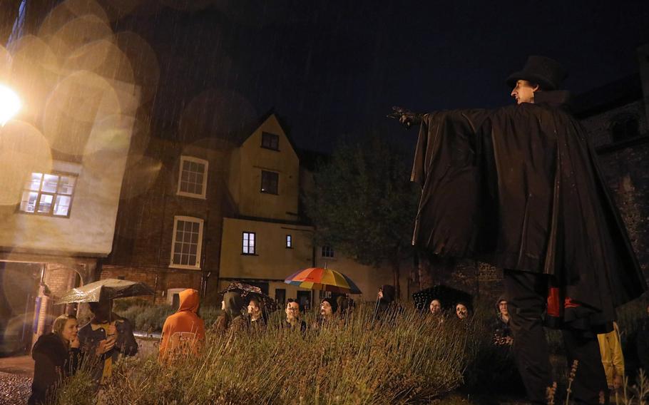 Le Morte points out a spookily significant local building in Tomb Alley during the Norwich Ghost Walk tour, Sept. 24, 2019.