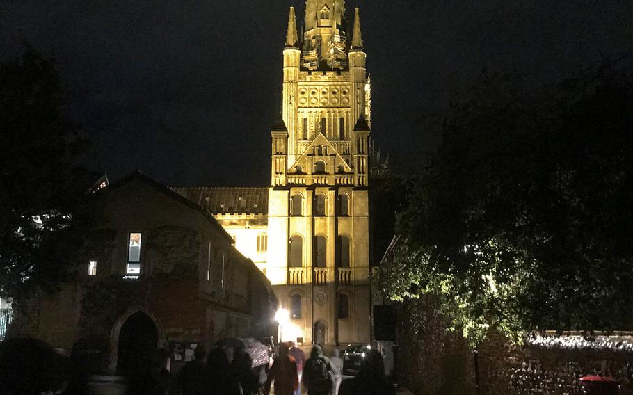 Individuals attending the Norwich Ghost Walk Elm Hill tour walk toward Norwich Cathedral at the start of the two-hour tour, Sept 24, 2019.
