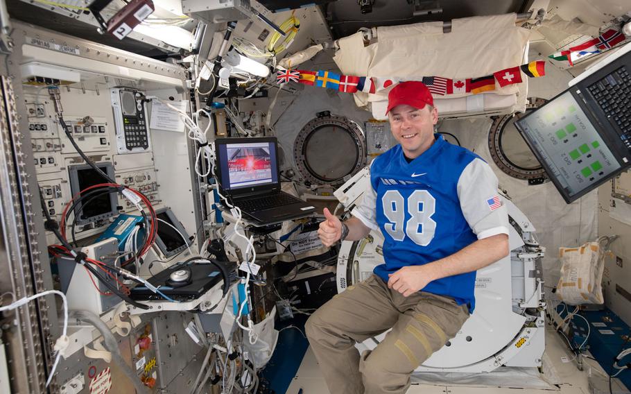 Astronaut Nick Hague watches a video his classmates from the Air Force Academy's class of 1998 sent him while aboard the International Space Station.