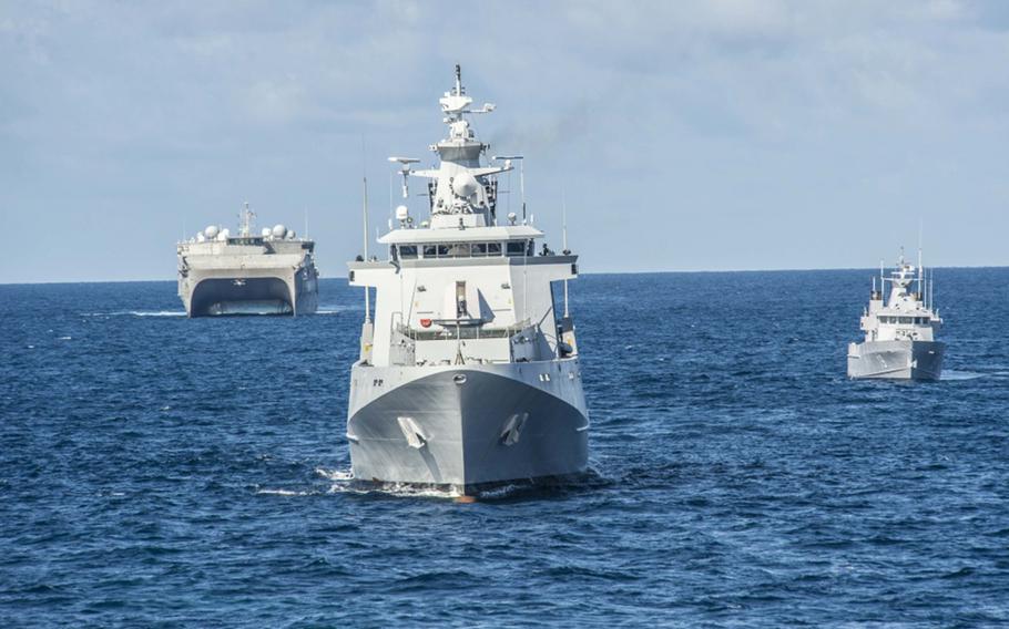 The USNS Millinocket, left, drills with Brunei navy vessels in the South China Sea during the Cooperation Afloat and Readiness and Training exercise, Wednesday, Oct. 30, 2019.