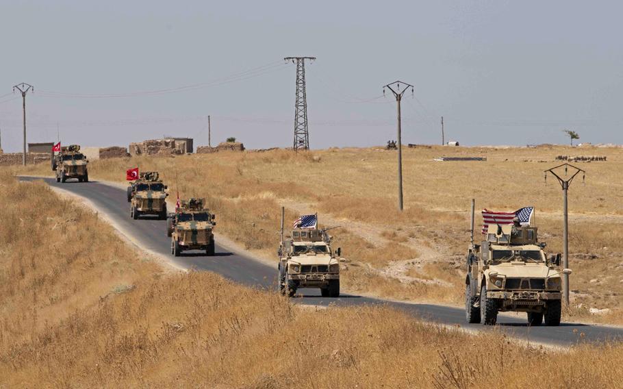 Turkish and U.S. military personnel conduct a joint patrol at the Syria-Turkey border in northeast Syria, Sept. 8, 2019. Turkey remains a transit point for foreign fighters looking to join the Islamic State in Iraq and Syria, and could help the terrorist group to regroup and regain influence, a U.S. report on global terrorism released Friday, Nov. 1, 2019, says.