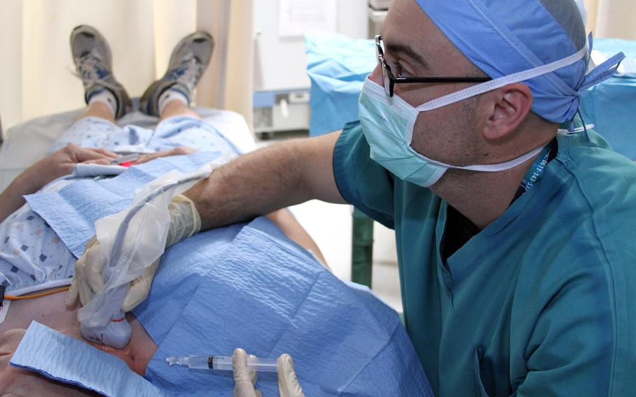Dr. Jeffrey Tiede, director of the Interdisciplinary Pain Management Center at Landstuhl Regional Medical Center, injects a local anesthetic into Master Sgt. Randall Kimble's neck during a stellate ganglion block procedure at LRMC in 2016. A Pentagon-funded clinical trial found that PTSD symptoms of service members who received the procedure showed significant improvement, according to the results announced Wednesday.