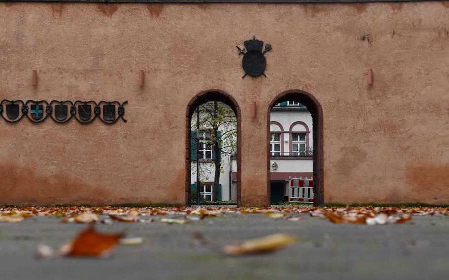Fall leaves are strewn across the bishop's courtyard outside St. Peter's cathedral in Worms, Germany.