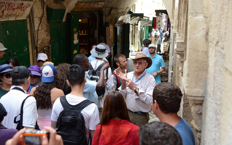 A tour group visits Jerusalem's Old City along the Via Dolorosa. U.S. European Command said Monday, Dec. 2, 2019, it has lifted an order restricting travel there, but American military personnel are still prohibited from visiting other parts of the West Bank, including Bethlehem and Jericho.