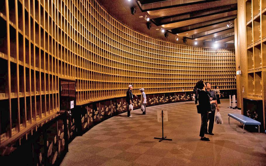 Visitors take in more than 3,000 Buddha statues on display inside the Ushiku Daibutsu in Tsukuba, Japan, Sept. 18, 2019.
