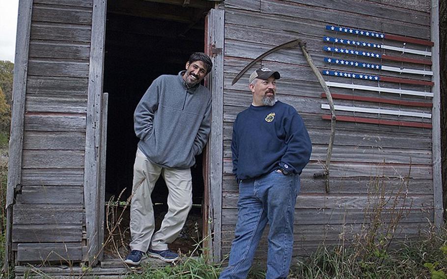 An interpreter from Iraq, nicknamed Phillip Morris, left, came to America through the special immigrant visa program with help from a soldier, Paul Braun, right, who he worked with in Iraq.