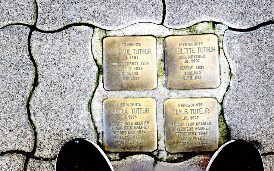 Four Stolpersteine on Alleestrasse in Kaiserslautern remember the Tuteur family. The word "ueberlebt" - German for survived - is inscribed at the bottom of the parents' stones, while the inscription on the stones of Carola and Claus, their children, says, "Murdered at Auschwitz." 