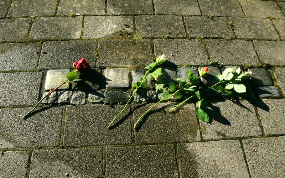 A red rose lies on the Stolperstein laid in Philipp-Mees-Platz in Kaiserslautern, Germany on Wednesday, February 5, 2020, in memory of Jonathan Volk, a political opponent of the Nazi regime.
