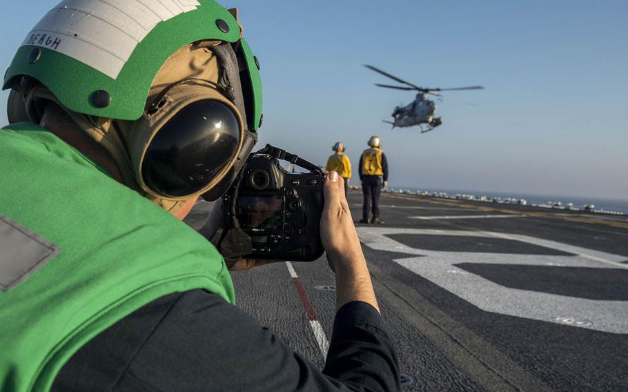 Petty Officer 3rd Class Jacob Bergh, a mass communication specialist, captures video of an AH-1Z Viper helicopter taking off from the USS Makin Island in November.