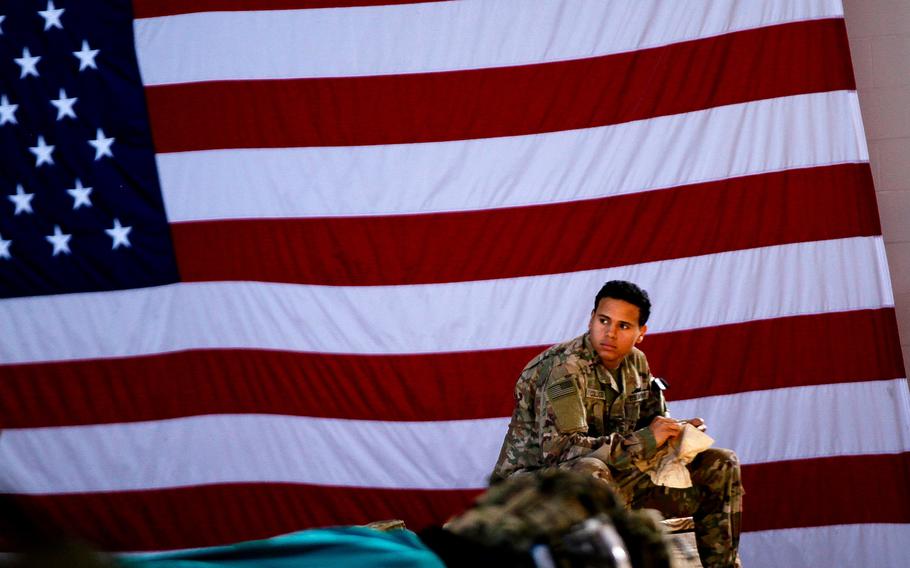 A soldier assigned to 1st Brigade Combat Team, 82nd Airborne Division waits to board an aircraft bound for the Middle East, from Fort Bragg, N.C. on January 5, 2020. Some 2,500 soldiers rapidly deployed days after Christmas and are now separated from their families indefinitely as the military works to fight the spread of the coronavirus.