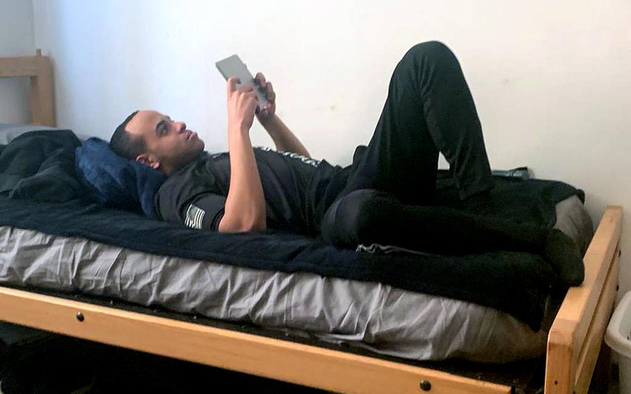 A soldier relaxes in his room on the Hohenfels Training Area, Germany, while restricted to the installation during the coronavirus outbreak. Under new hardship duty pay, service members who are required to self-isolate but can't do so at home or in government-provided quarters, could receive $100 a day for up to 15 days each month.