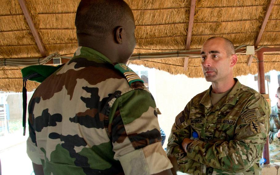 Col. Bradley D. Moses, commander of 3rd Special Forces Group, speaks with the commander of Nigerien special operations forces in Niger, Sept. 6, 2017. Moses' nomination for a promotion was withdrawn by the Army, unnamed defense officials said Friday, according to The New York Times.