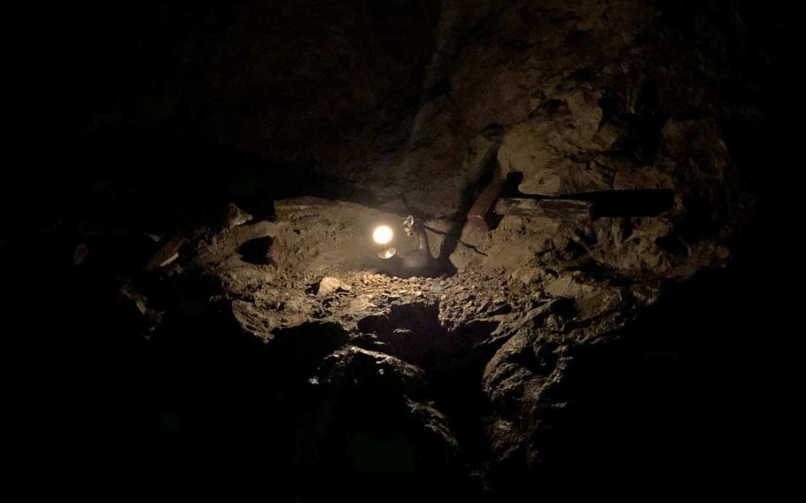 A display shows how miners long ago illuminated the Steinkaulenberg mine, in Idar-Oberstein, Germany, with a candle to dig for gems.