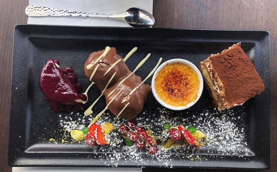 On the plate is a small creme brulee, tiramisu, panna cotta, zabaione, mixed fruit and cream at La Cantinetta in Wiesbaden, Germany.