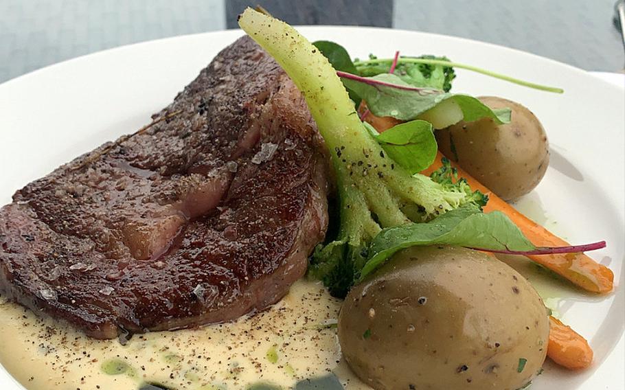 Beef with a signature sauce, served with potatoes and vegetables, is one of the main courses available at the Yachtova restaurant in Mikolajki, Poland. The sign in the background says that the table has been disinfected, one of many preventive measures the restaurant takes against the coronavirus.