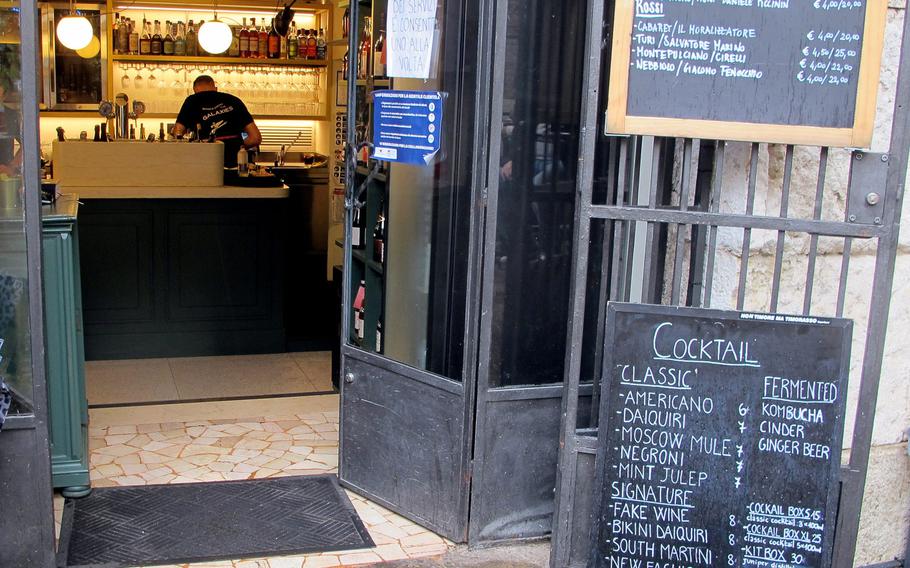 The Cantina del Tormento's kitchen and wine collection is located inside the Basilica Palladiana but all tables are outdoors. Wine, cocktails and appetizers are listed on two chalkboards.
