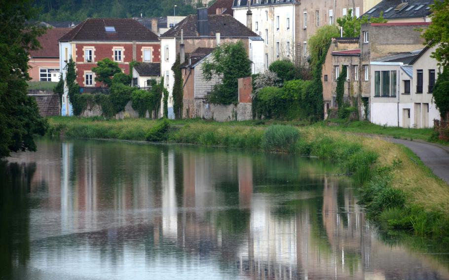 Houses in Sarreguemines, France, reflect in the Saar River on Weds., June 17, 2020. Sarreguemines is at the western end of the 80-mile Glan-Blies bike path, on the right in the picture, which runs from Staudernheim, north of Kaiserslautern, Germany, to Sarreguemines.