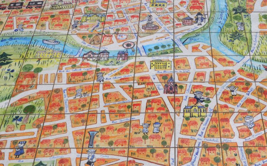 A map made of ceramic tiles lies to one side of the bike path that runs past the center of Sarreguemines, France. Sarreguemines is known for its ceramics.