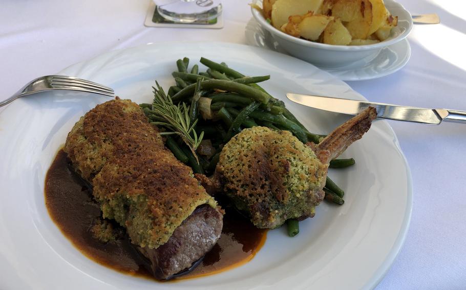 The saddle of lamb with herb crust, accompanied by fried potatoes and green beans, was tender and juicy.